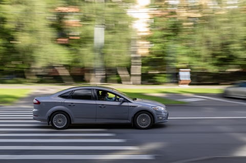 Ford Mondeo car drives along a city street