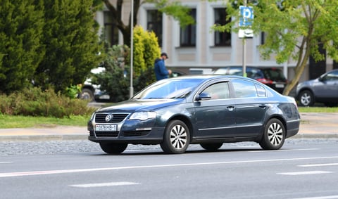 Dark blue Volkswagen Passat B6 sedan moving along a city street